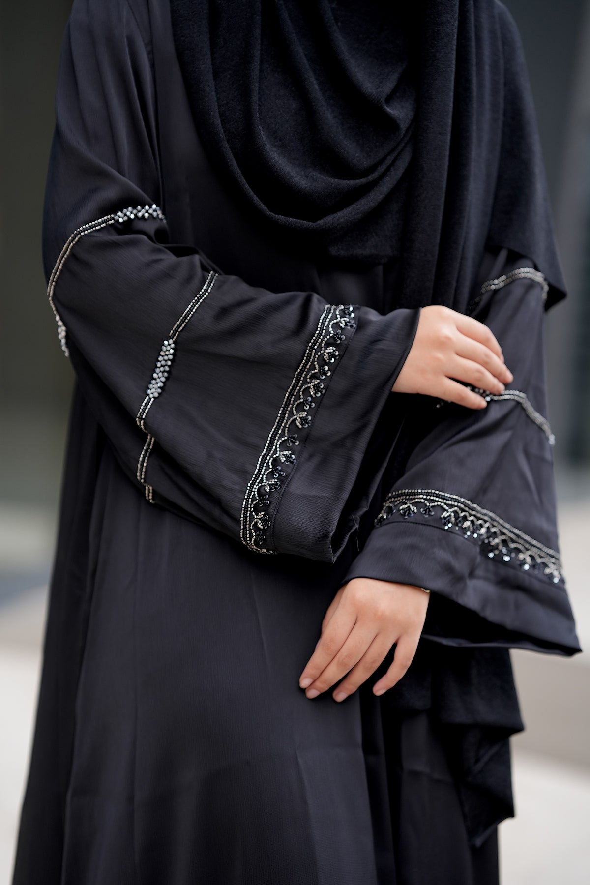 Close-up of 100% handmade antique silver detailing by skilled artisans on the sleeves of the Modest Collection Andalus Abaya.