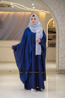Woman wearing a blue batwing shrug abaya and light gray hijab in a Modest Collection outlet