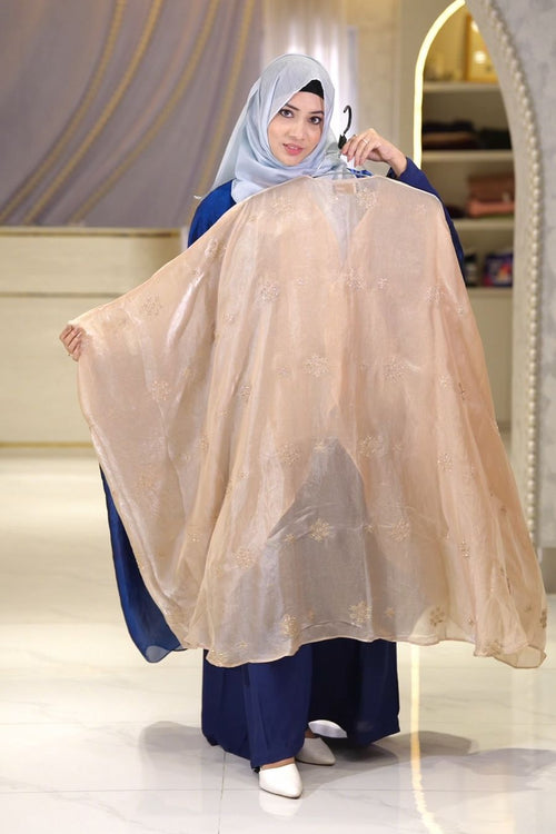 Woman wearing cream silk modest dress with elegant modest fashion styling