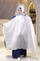 Woman holding a white garment in a store setting