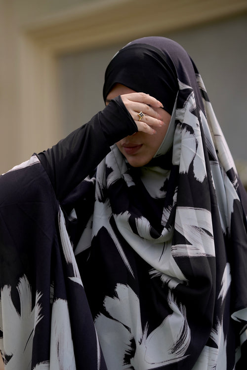 Close-up of the finger gloves system sleeve on a black printed jilbab, offering graceful coverage and ease of movement.