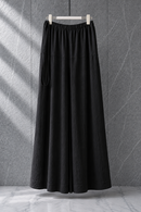 Black extra-flared palazzo pants by Modest Collection featuring a secure side zipper pocket and adjustable waist, styled for maternity and office wear.