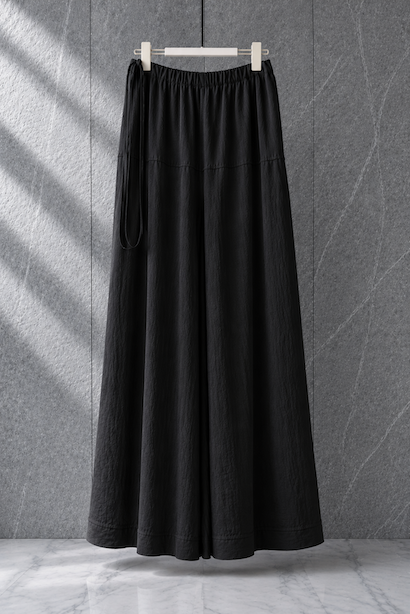 Black extra-flared palazzo pants by Modest Collection featuring a secure side zipper pocket and adjustable waist, styled for maternity and office wear.