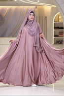A luxurious rose-pink Orchid Silk abaya featuring a fluid drape, elegant soft sheen, and wide sleeves. A premium modest dress ideal for wedding guest attire, festive celebrations, and special occasions.