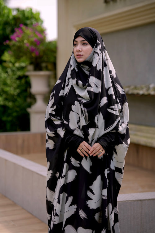 Elegant printed black jilbab styled with a stretchable head belt for a secure, custom, and comfortable daily fit.