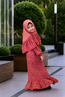 A young girl wearing the Little Lyra modest georgette dress with frill details and matching hijab.