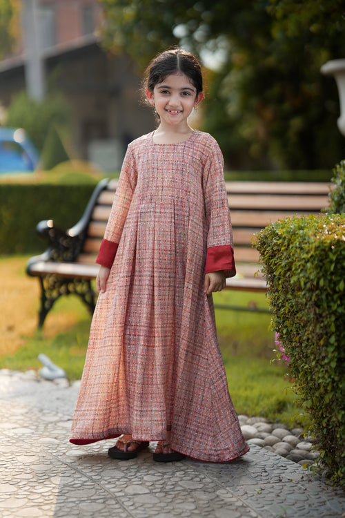 Young girl wearing the Little Meadow Abaya in woven rose-rust textured georgette.