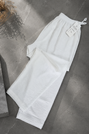 White trousers by Modest Collection featuring a fully elasticized waist, pleated hemline, and breathable CEY Crumble Cotton fabric, ideal for summer modest style.
