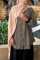 Elegant curved hem detail on a modest plaid shirt