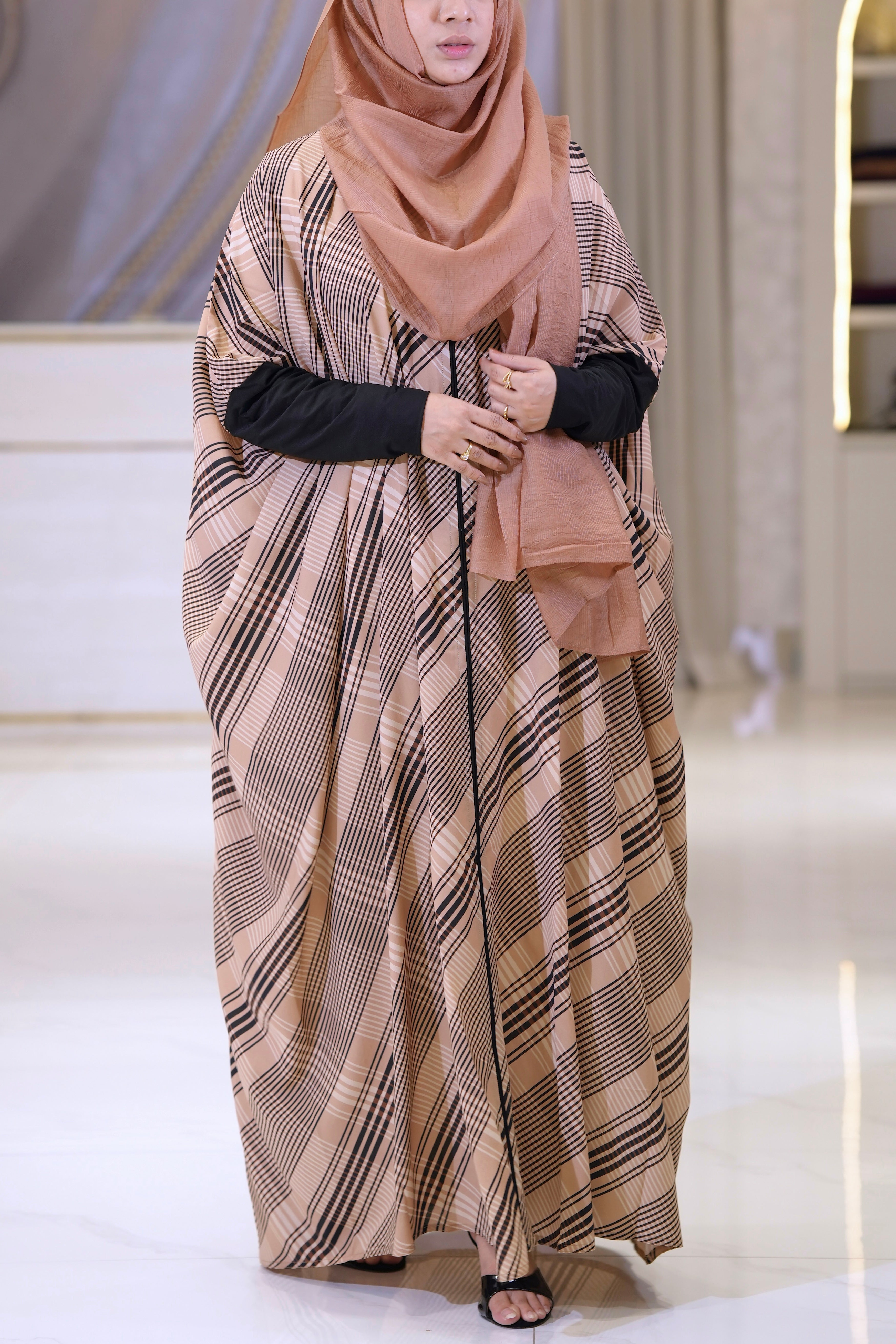 Women wearing the Safiya Striped Kaftan, a non-transparent, lightweight georgette abaya with front buttons.