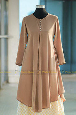 Woman wearing an elegant ivory flared godet kurti made from breathable cherry fabric, suitable for maternity and formal modest wear