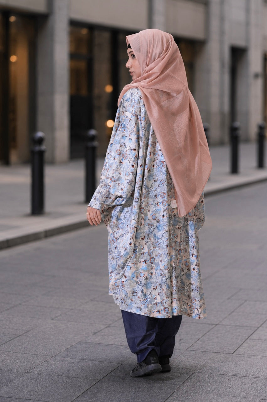 A woman wearing the comfortable, free-size Tanaka Top in Azure, showcasing its flattering drape and modest 42-inch length.