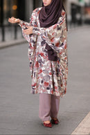 Woman wearing a patterned tanaka maternity top and hijab on a city street