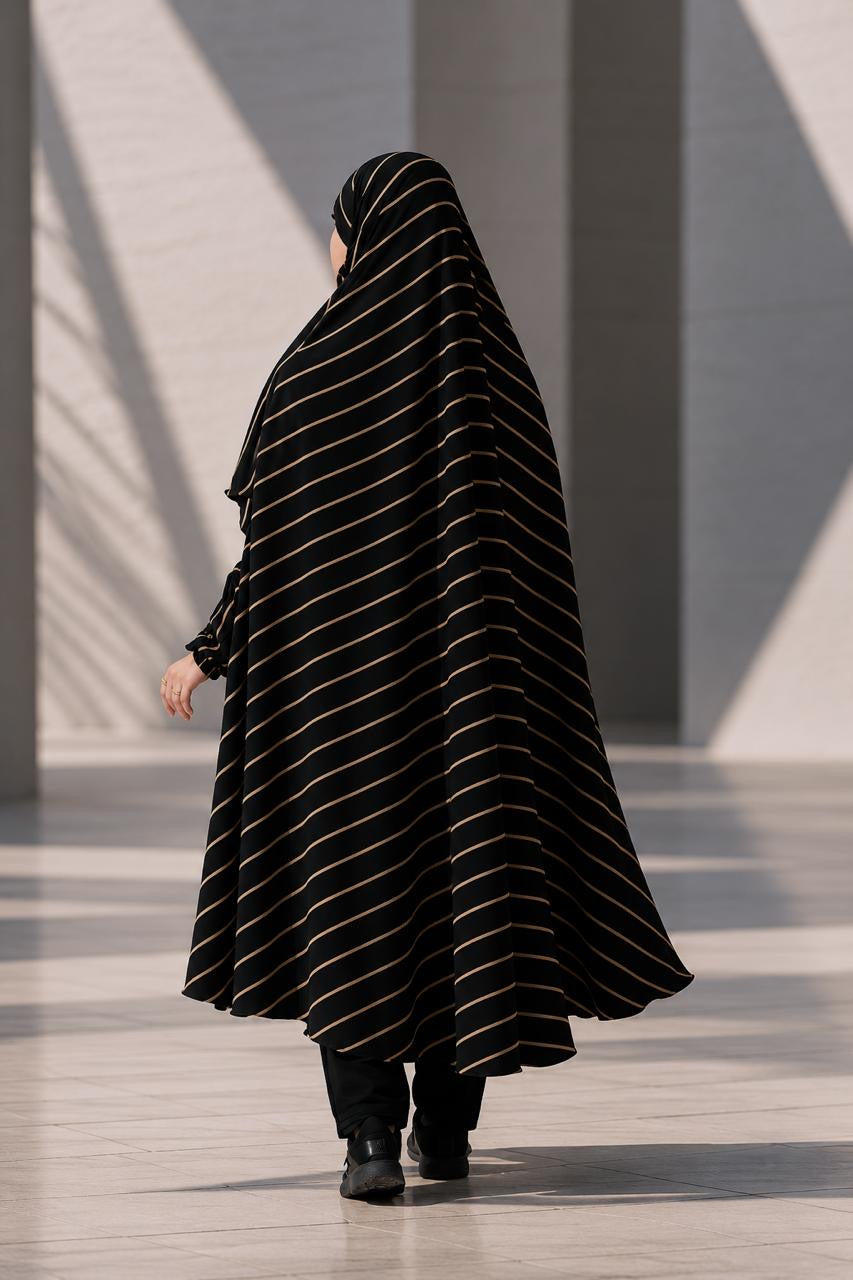Back view of a woman wearing the flowing Urban Stripe Khimar, highlighting the elegant drape of the georgette material.