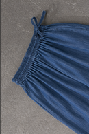 Blue denim trousers on a gray surface